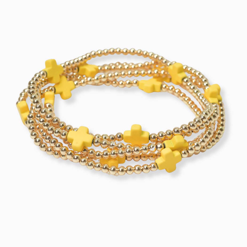 Multi layered gold bead stretch bracelet with cross accent n