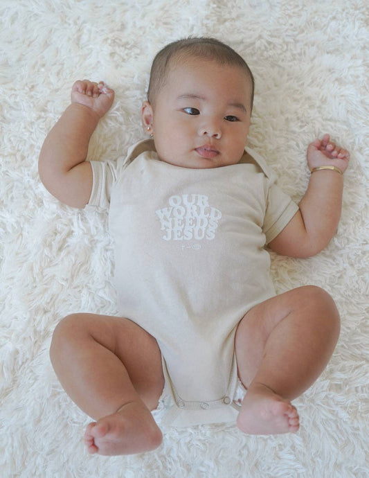 Our World Needs Jesus Beige Onesie